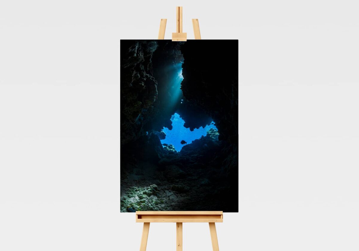 Print of an underwater cave with a light leak shining through on the Great Barrier Reef