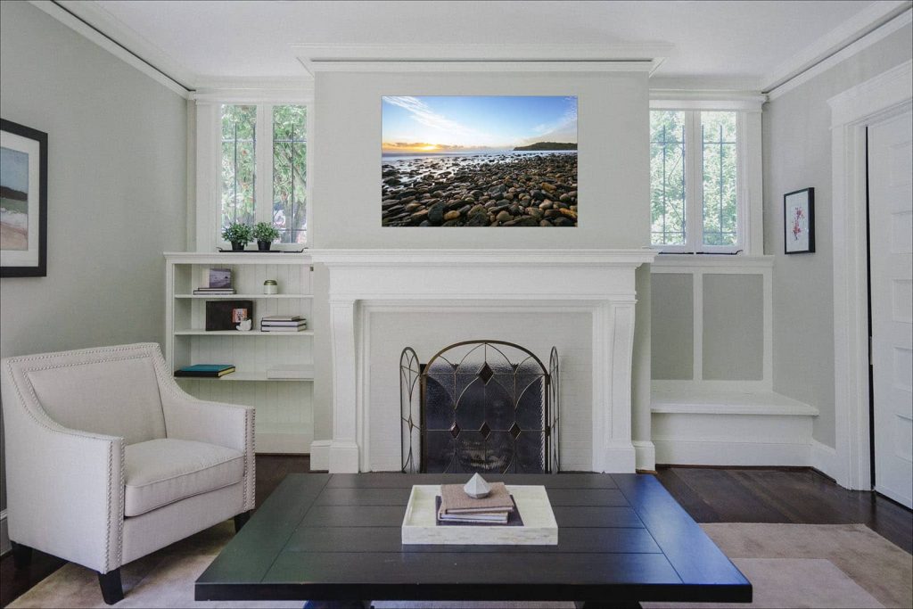 Sunrise at pebbly beach photographic metal print hanging above the fireplace