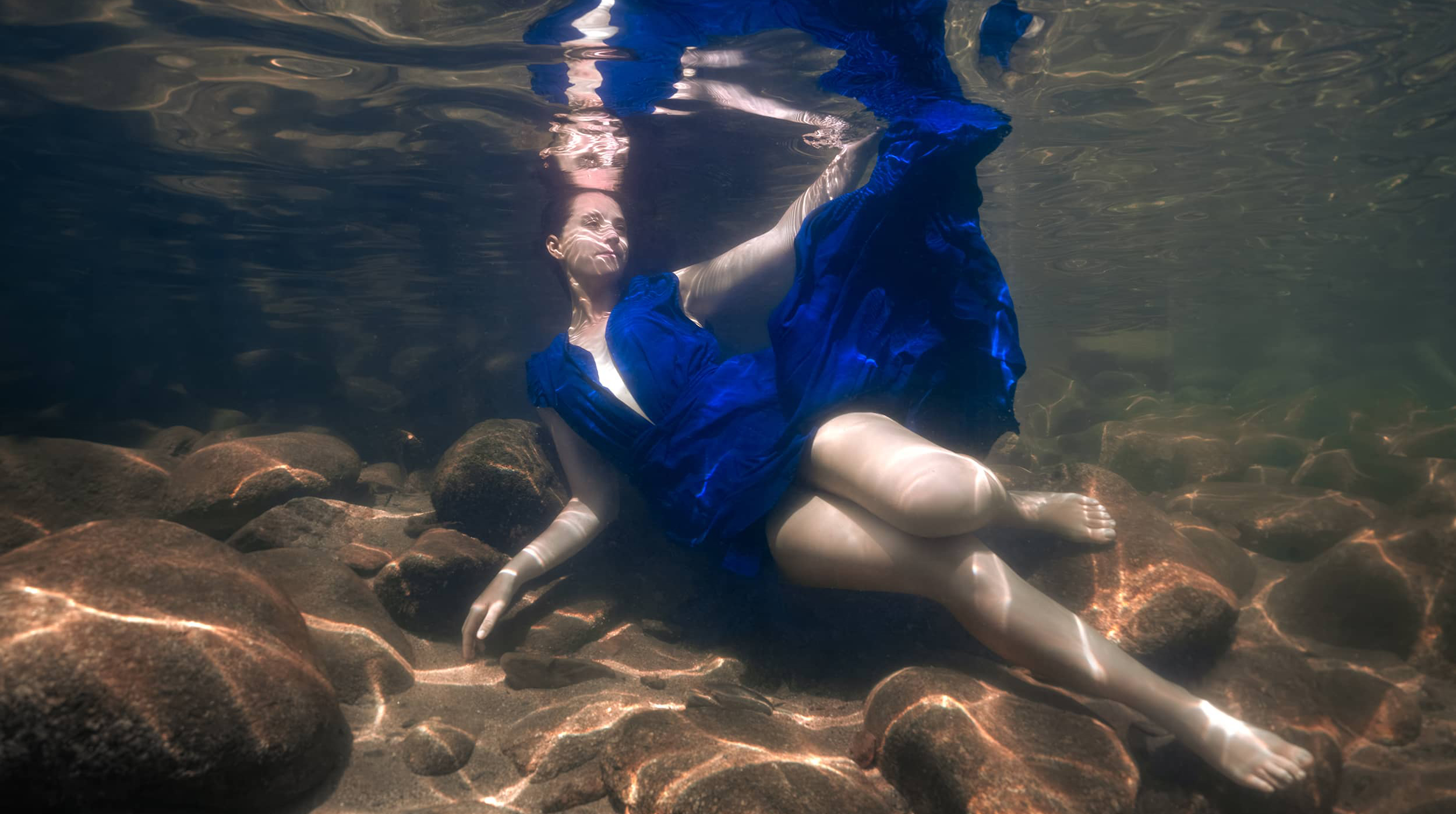 angelina-pilarinos copy underwater portrait of a woman wearing a flying dress