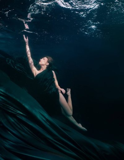 underwater portrait of a woman wearing a flying dress