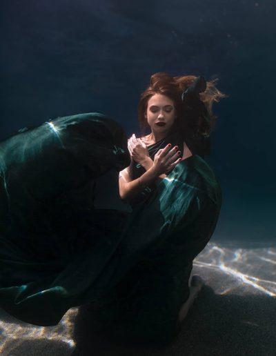underwater portrait of a woman wearing a flying dress