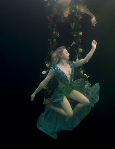 underwater portrait of a woman on a floral swing