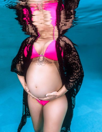Close-up of expecting mother’s baby bump during Port Douglas underwater maternity session
