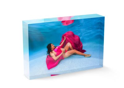 Pregnant woman in flowing pink fabric during an underwater maternity photoshoot in Cairns printed on an acrylic block.