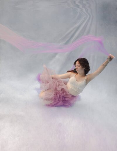 Underwater portrait of a woman on a white background