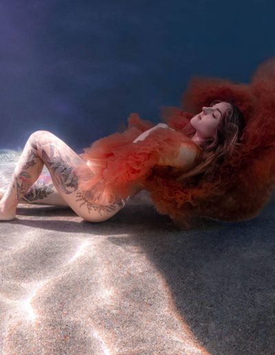Townsville maternity underwater photoshoot with vibrant dress and gentle poses