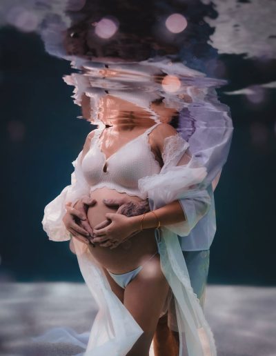 Close-up of expecting mother’s baby bump during Cairns underwater maternity session