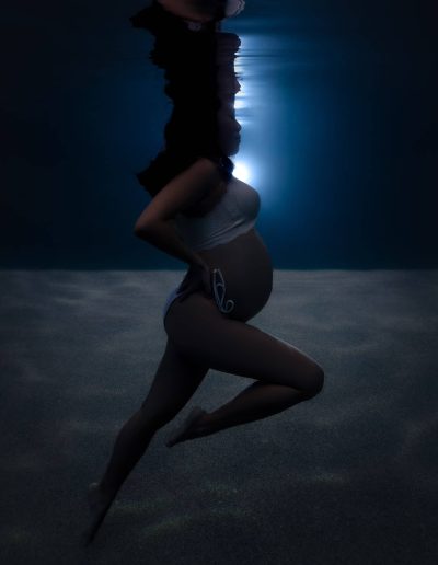 Underwater maternity photographer capturing expecting mother in Far North Queensland