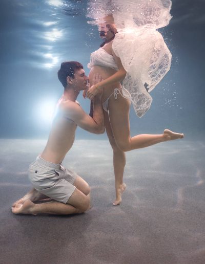 Underwater maternity session with partner in heated Cairns swimming pool