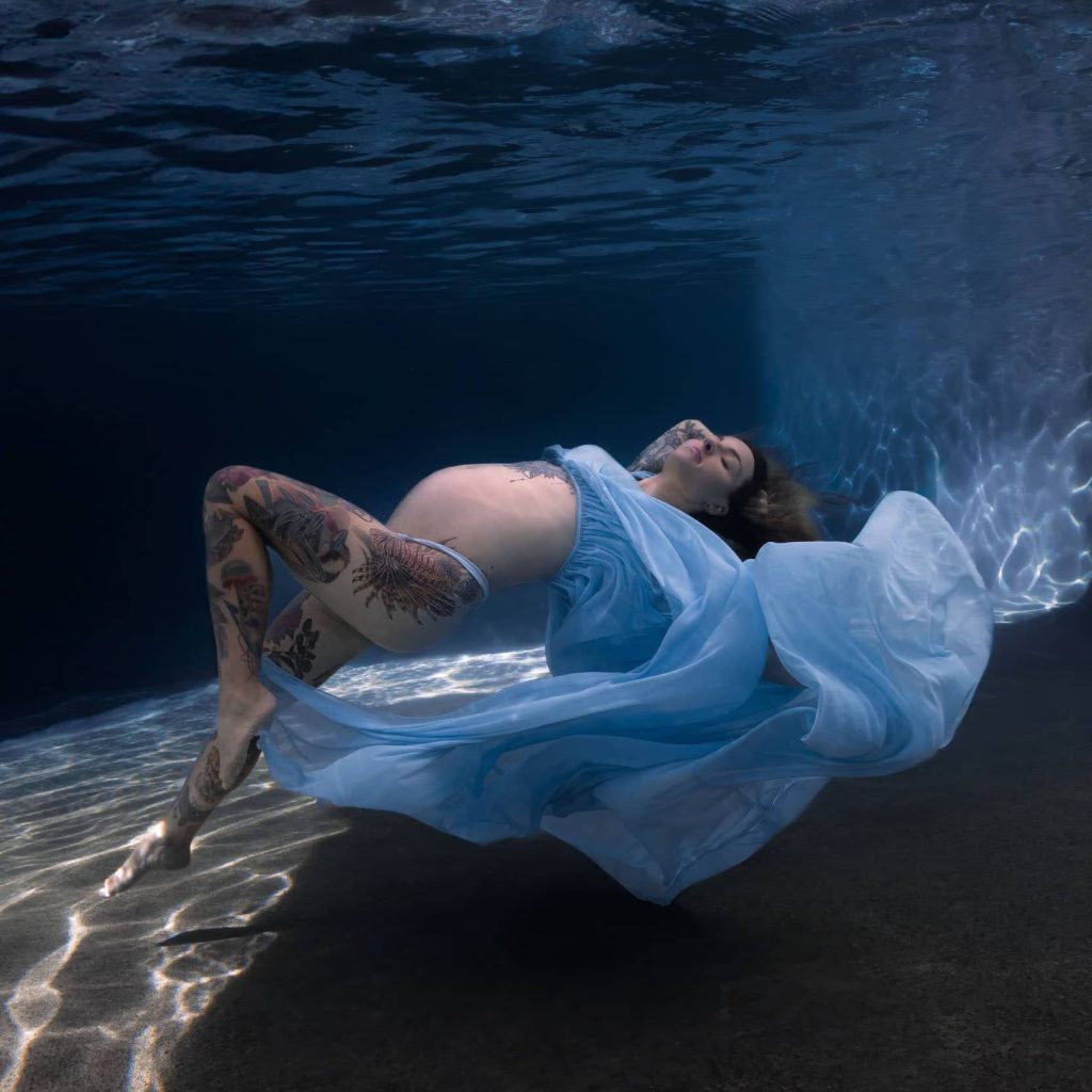 Townsville maternity underwater photoshoot with vibrant dress and gentle poses